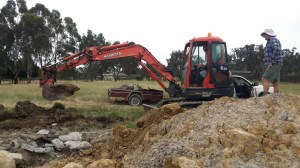 Matt getting a crash course on using a excavator from Mal