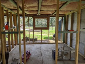 Bedroom 2 with one side of the wall covered in building paper