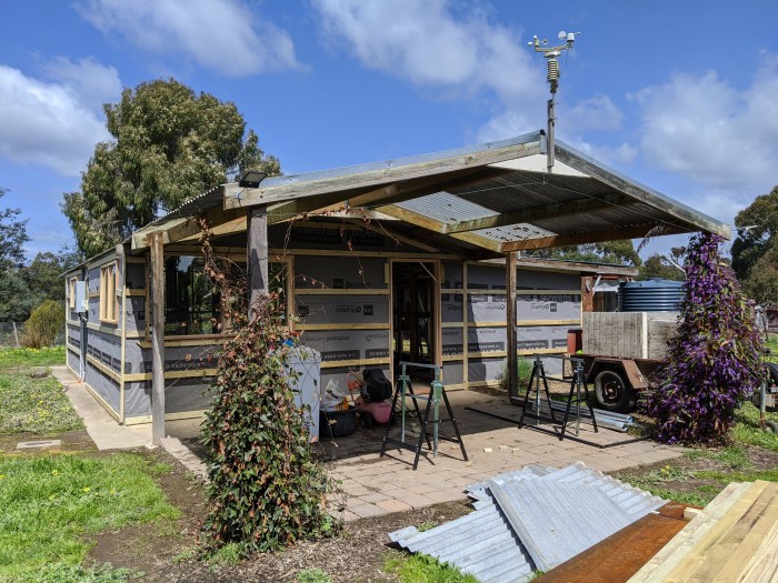 North east view of the kitchen and front door, with timber slats and building paper in place